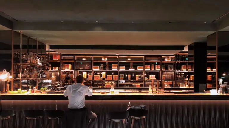 Man sitting at a hotel bar by himself.