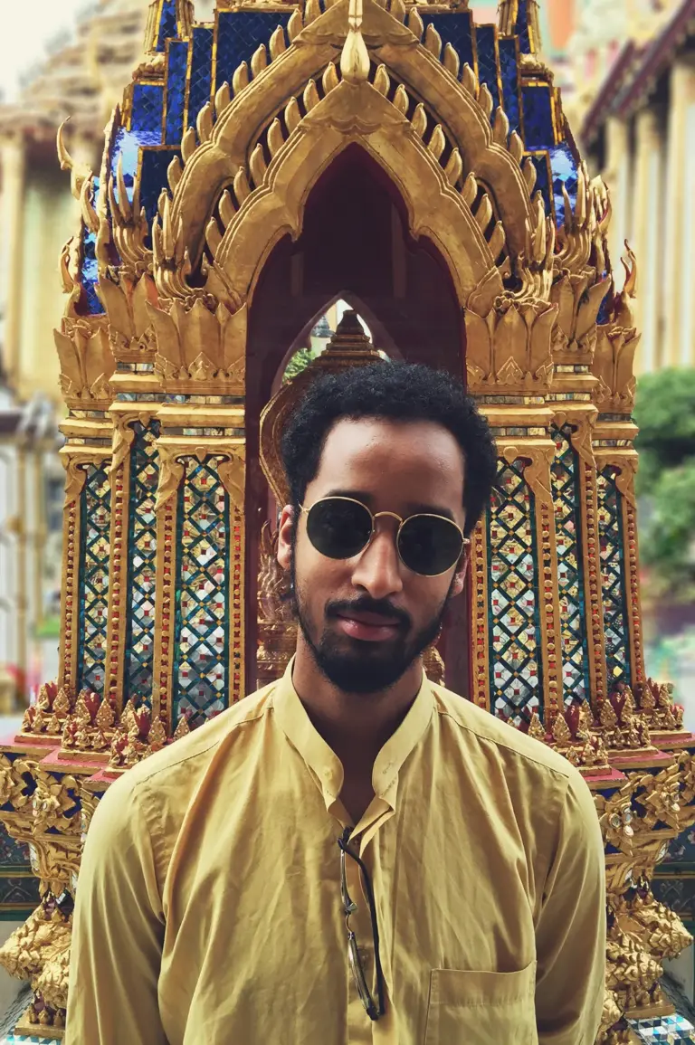 Man in a yellow shirt posing for the camera in Thailand.